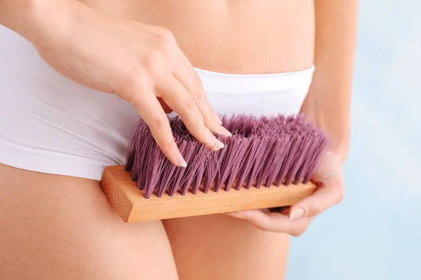 Beautiful young woman with cleaning brush on light background, closeup. Depilation concept — Stock Photo, Image