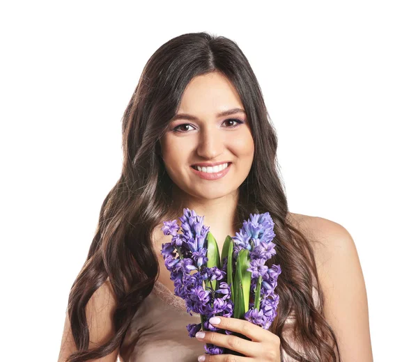 Vacker ung kvinna med hyacint blommor på vit bakgrund — Stockfoto