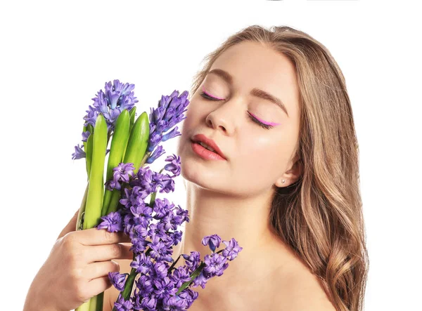 Beautiful young woman with hyacinth flowers on white background — Stock Photo, Image