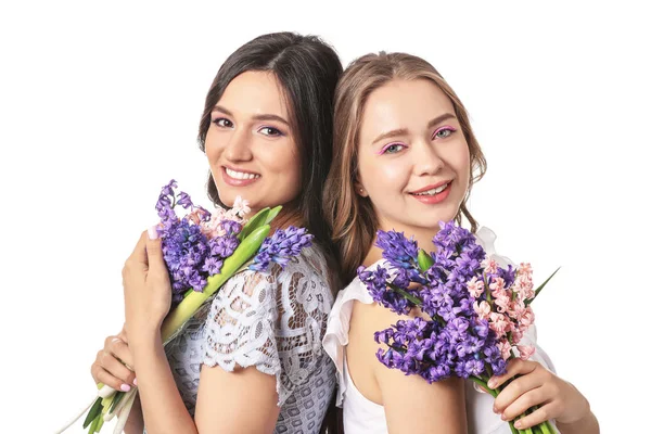 Beautiful young women with hyacinth flowers on white background — Stock Photo, Image