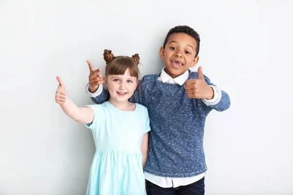 Portrait of cute children showing thumb-up on white background — Stock Photo, Image