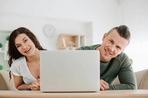 Adorable loving couple with laptop at home — Stock Photo, Image