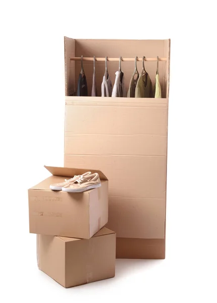 Wardrobe boxes with clothes on white background — Stock Photo, Image