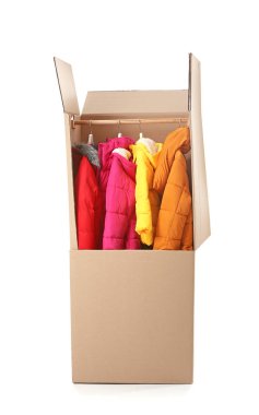 Beyaz arka planda giysileri olan gardırop kutusu.