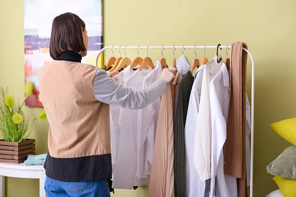 Stylish young woman choosing clothes in her dressing room at home — Stock Photo, Image