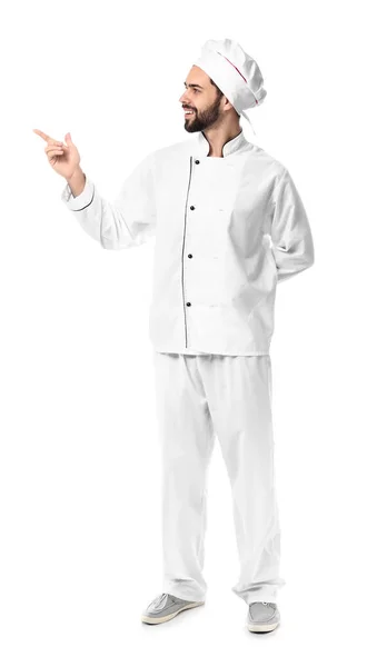 Handsome male chef pointing at something on white background — Stock Photo, Image