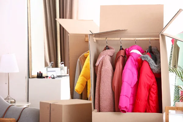 Wardrobe boxes with clothes in room