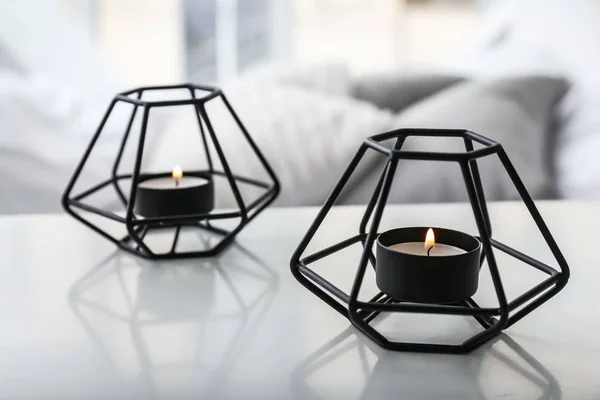 Beautiful burning candles on table in bedroom — Stock Photo, Image