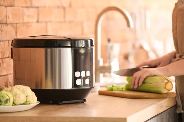 Woman using modern multi cooker in kitchen — Stock Photo, Image