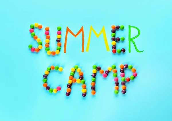 Words SUMMER CAMP made of candies on color background — 스톡 사진