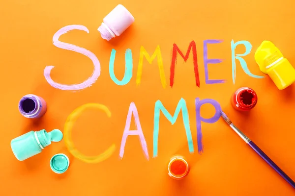 Words SUMMER CAMP, paints and brush on color background — Stock Photo, Image