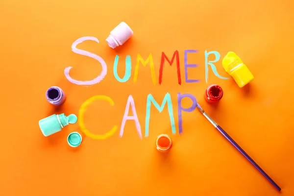 Words SUMMER CAMP, paints and brush on color background — Stock Photo, Image