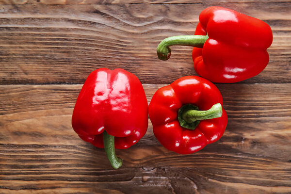 Ripe red peppers on wooden background