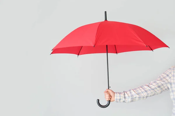 Female hand with stylish umbrella on light background — Stock Photo, Image