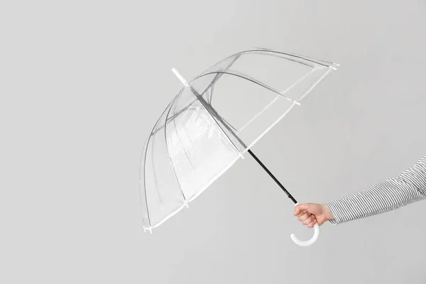 Mano femenina con paraguas elegante sobre fondo claro — Foto de Stock