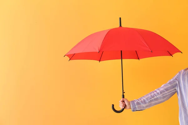 Female hand with stylish umbrella on color background — Stock Photo, Image