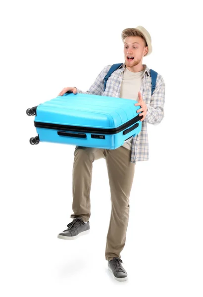 Emotional young tourist with heavy luggage on white background — Stock Photo, Image