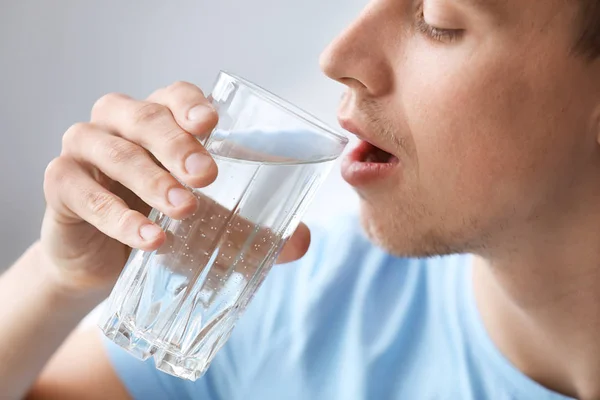 Handsome man drinking water at home, closeup — Stock Photo, Image