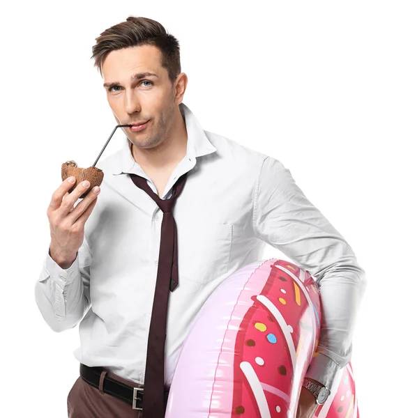 Handsome accountant with cocktail and swimming ring dreaming about vacation on white background — Stock Photo, Image