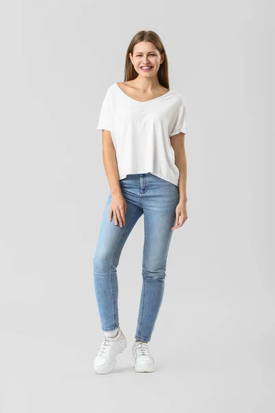 Beautiful young woman in jeans on white background — Stock Photo, Image