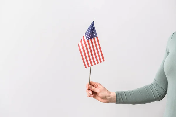 Female hand with USA flag on light background — Stock Photo, Image