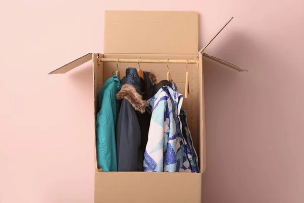 Wardrobe box with clothes on white background