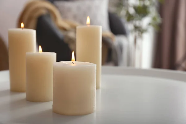 Hermosas velas encendidas en la mesa en la habitación — Foto de Stock