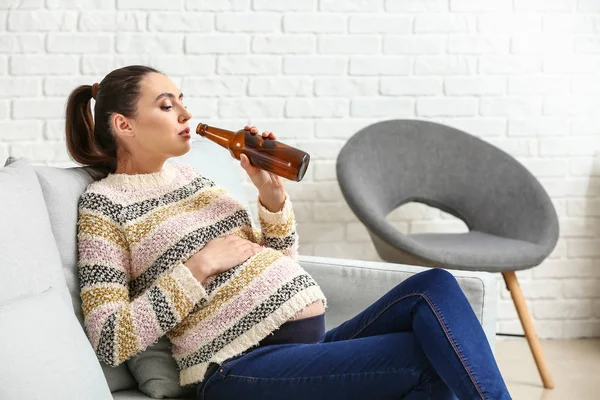 Mulher grávida bebendo cerveja em casa — Fotografia de Stock