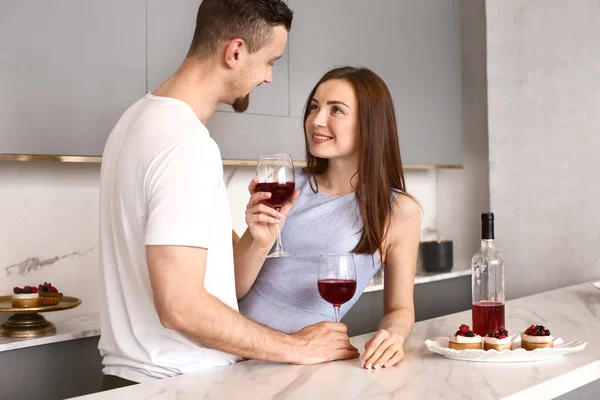 Happy young couple drinking wine at home — Stock Photo, Image