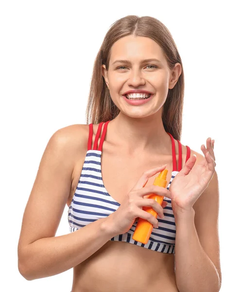 Beautiful young woman with bottle of sun protection cream on white background — Stock Photo, Image