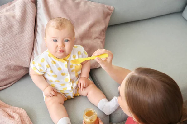 Mother feeding her little baby at home — Stock Photo, Image