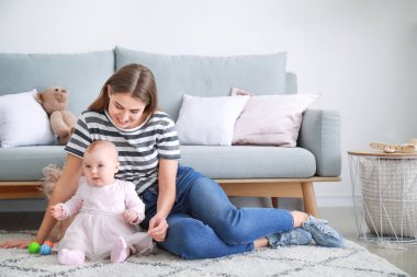 Mutlu anne ve evde küçük şirin bir bebek.