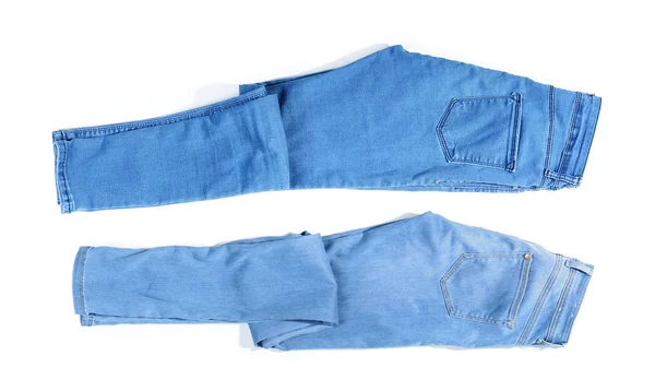 Olika jeans byxor på vit bakgrund — Stockfoto