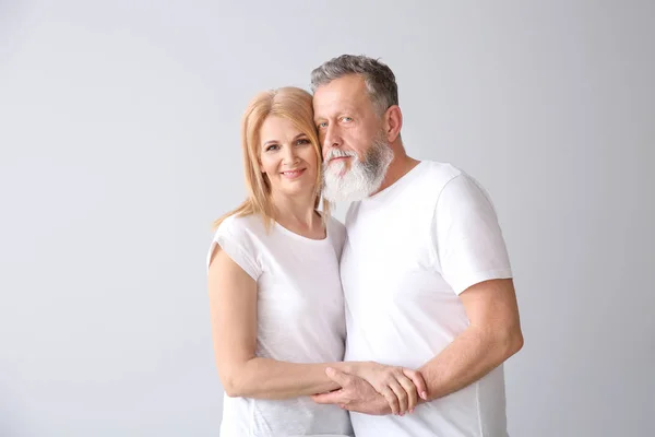 Beautiful elderly couple on light background — Stock Photo, Image