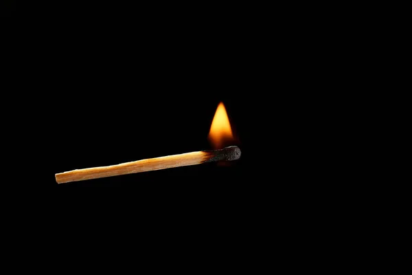 Burning match on dark background — Stock Photo, Image