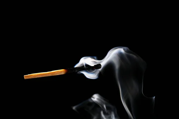 Burnt out match on dark background — Stock Photo, Image