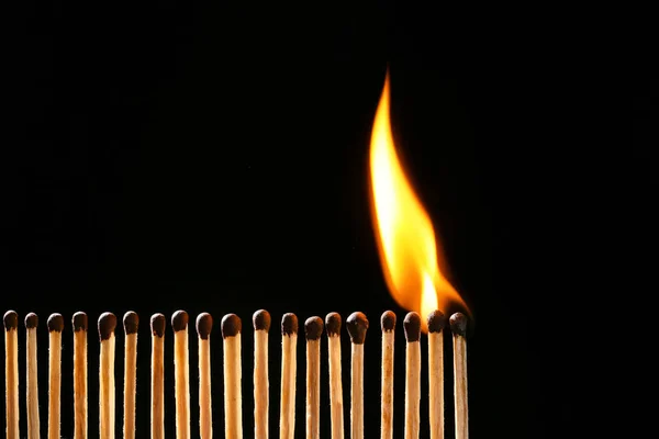 Burning matches on dark background — Stock Photo, Image