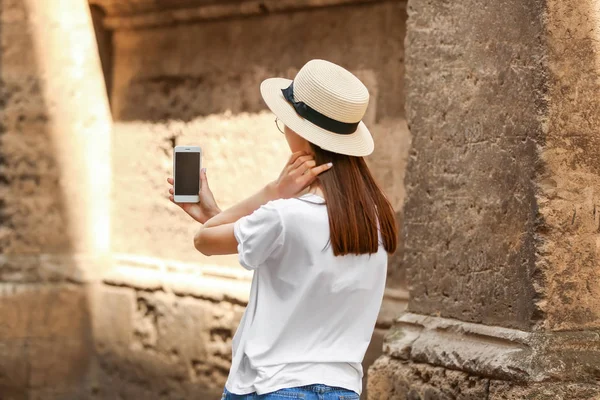 Ung kvinna med mobiltelefon utomhus — Stockfoto