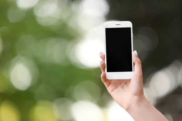 Young woman with mobile phone outdoors — Stock Photo, Image