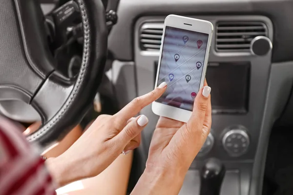 Водитель автомобиля с помощью мобильного телефона для навигации — стоковое фото