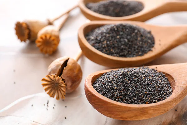 Spoons with poppy seeds on table, closeup — Stock Photo, Image