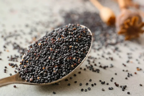 Spoon with poppy seeds on table, closeup — Stock Photo, Image