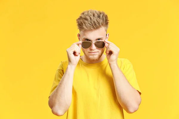 Portrait of handsome young man on color background — Stock Photo, Image