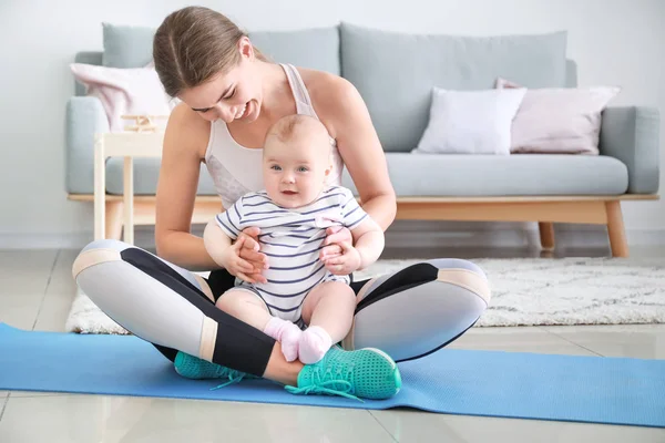 Mother training with cute little baby at home — Stock Photo, Image