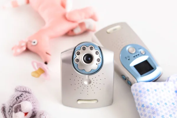Modern baby monitor and toys on table — Stock Photo, Image