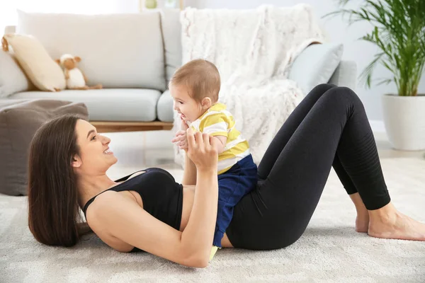 Mother training with cute little baby at home — Stock Photo, Image