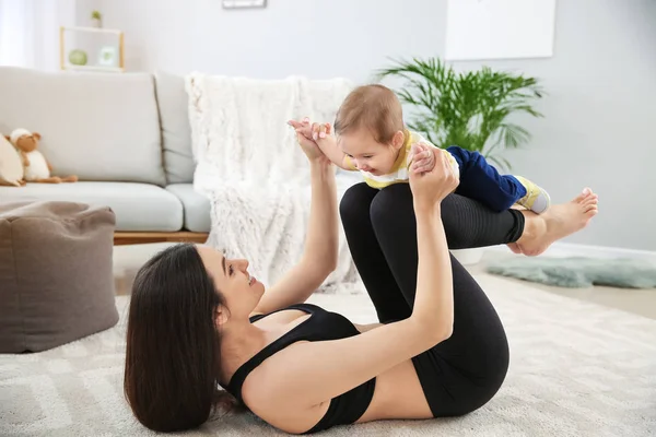 Mother training with cute little baby at home — Stock Photo, Image