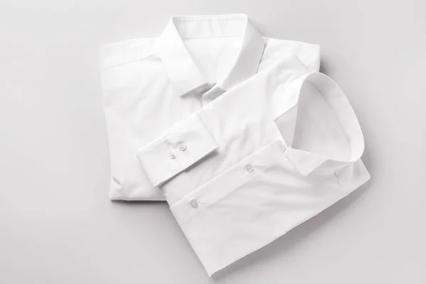 Shirts after dry-cleaning on light background — Stock Photo, Image