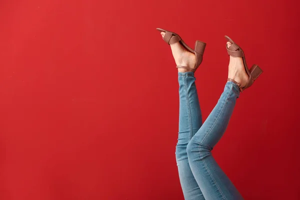 Legs of young woman in stylish shoes on color background — Stock Photo, Image