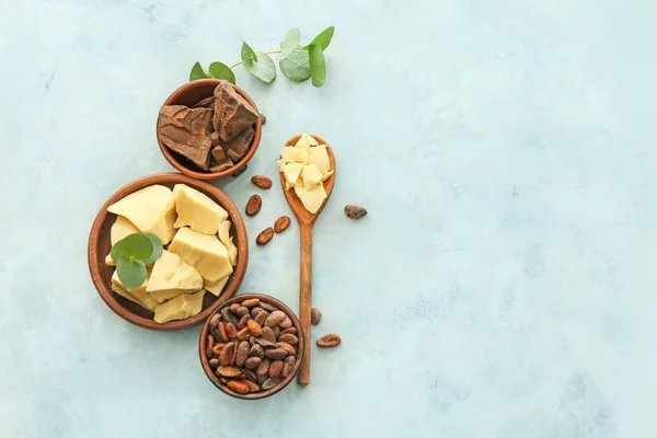 Composition with cocoa butter, beans and chocolate on light color background